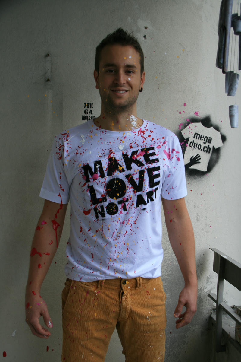 Nils Mango with a t-shirt saying MAKE LOVE NOT ART, sprinkled with colorful paint.